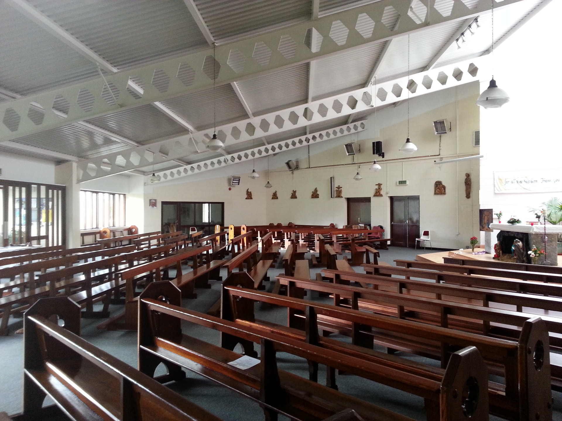The nave of St. Ronan's Church with wooden pews and clerestory windows