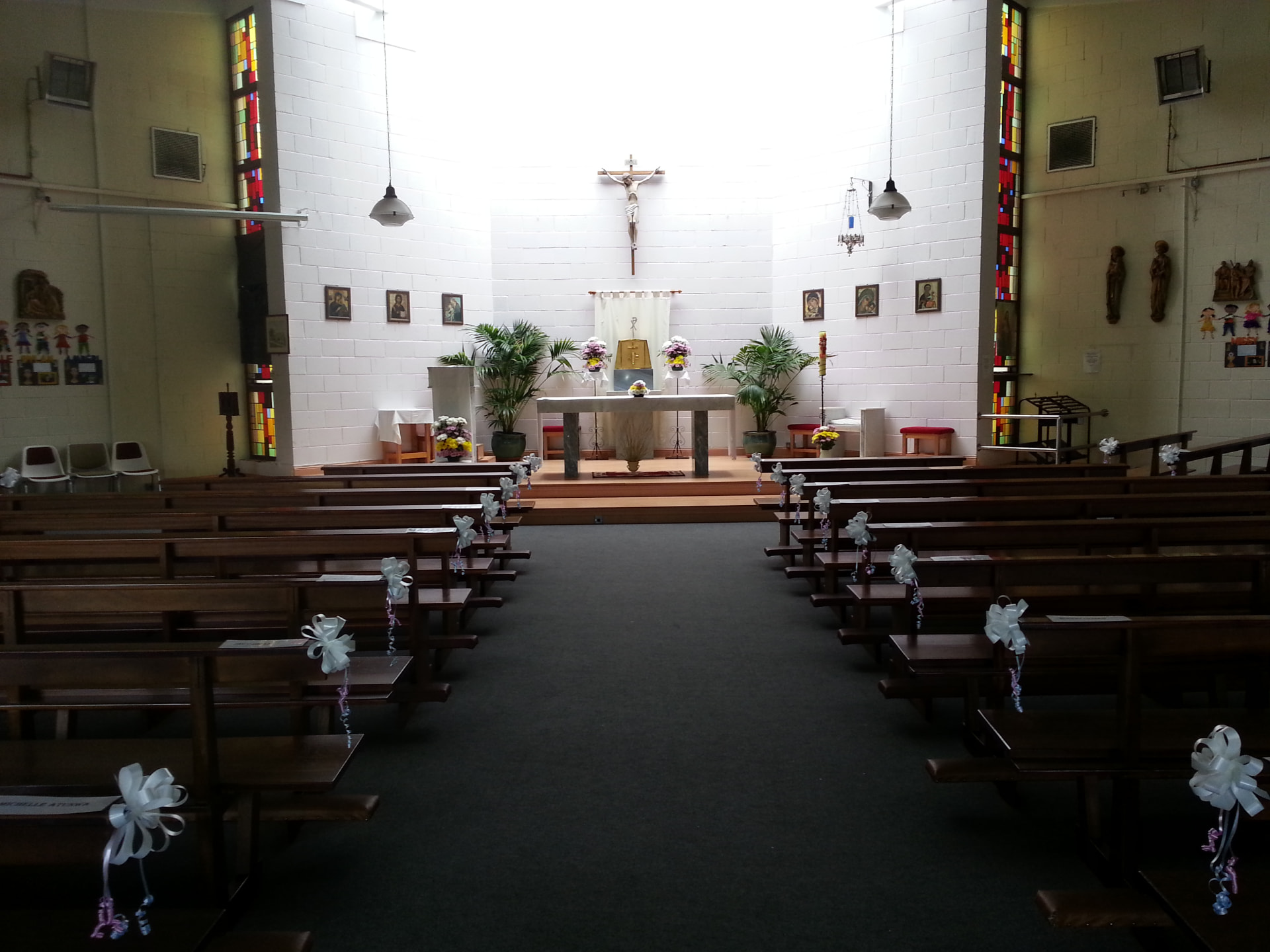 The sanctuary of St. Ronan's Church with the crucifix, altar and stained glass